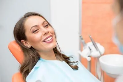 woman smiling in the dental chair at Broadway Heights Dental
